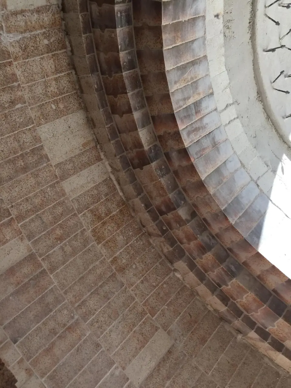 Curved refractory brickwork inside industrial equipment