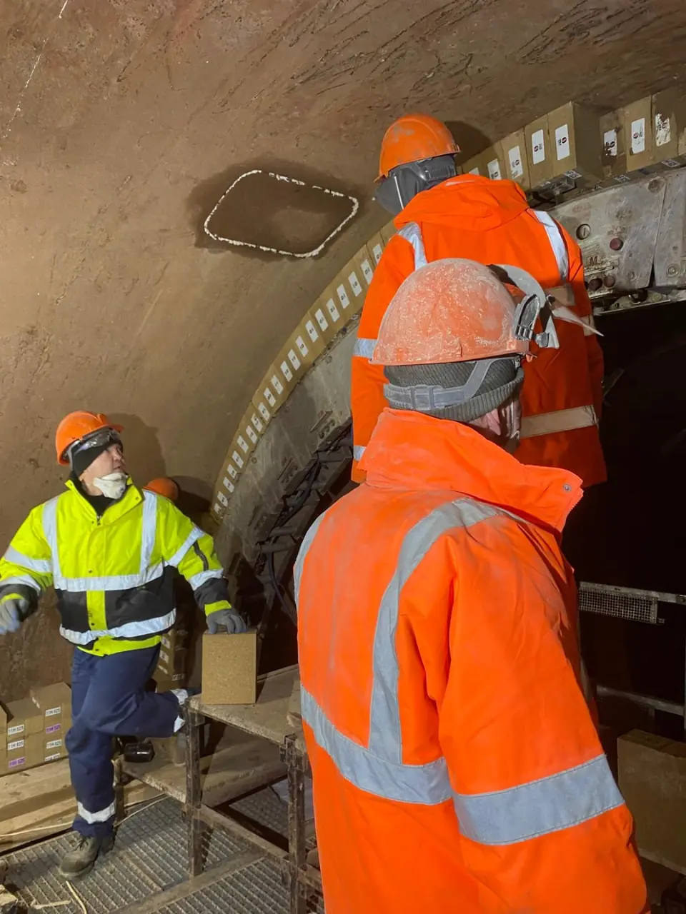 Site team at work inside lined process equipment